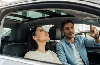 a couple checking new car with sunroof in showroom